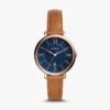 Fossil women's watch with blue face and brown leather strap. Elegant timepiece.