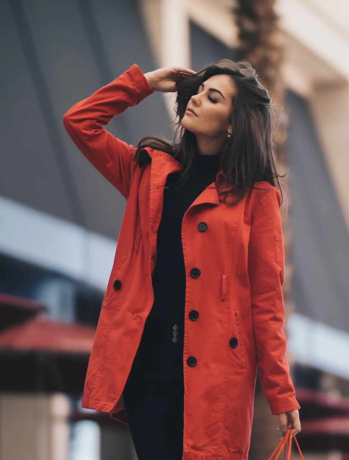 Woman in a stylish red coat standing outside