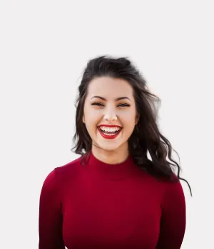 Smiling woman with red lipstick and a red turtleneck sweater.